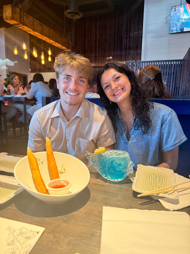 Laughing at dinner over a blue drink shaped like a fish